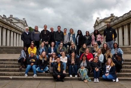 Students gathered at Greenwich on some steps for a group photo
